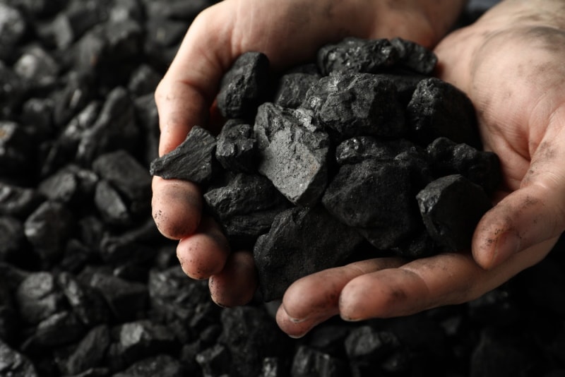 man holding coal