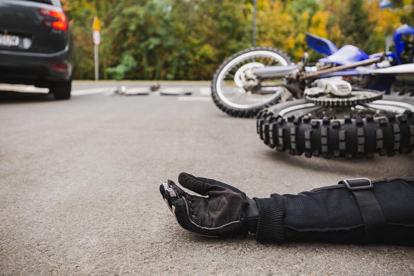man on the road after fatal car and motorcycle accident