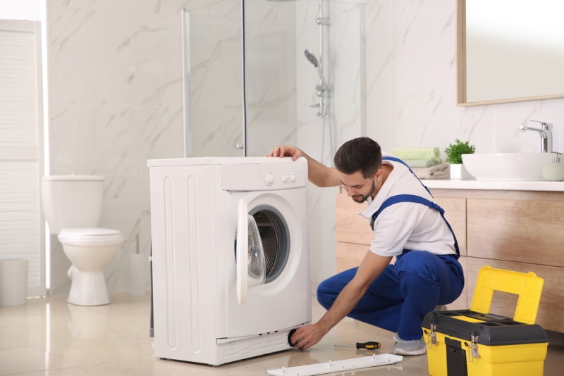 man reparing washing machine