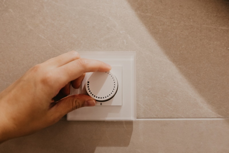 man turning light dimmer