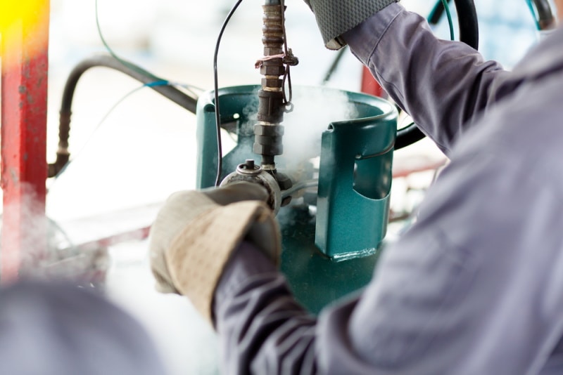 man working on propane tank