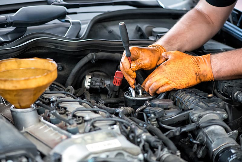 mechanic repairing diesel engine