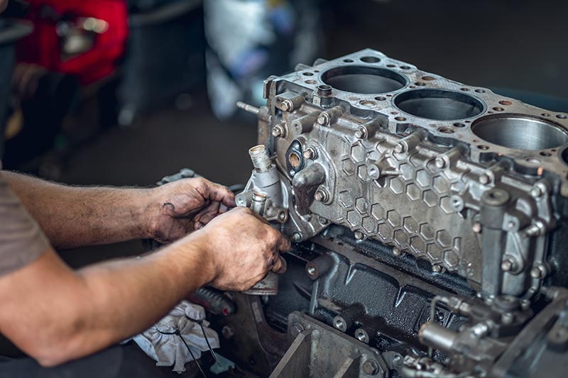 mechanic repairing diesel engine
