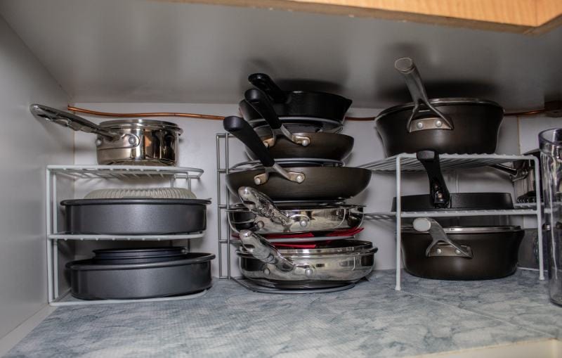 organized kitchen cabinet with pots and pans