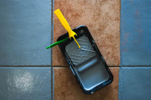 paint roller and brush on tile floor