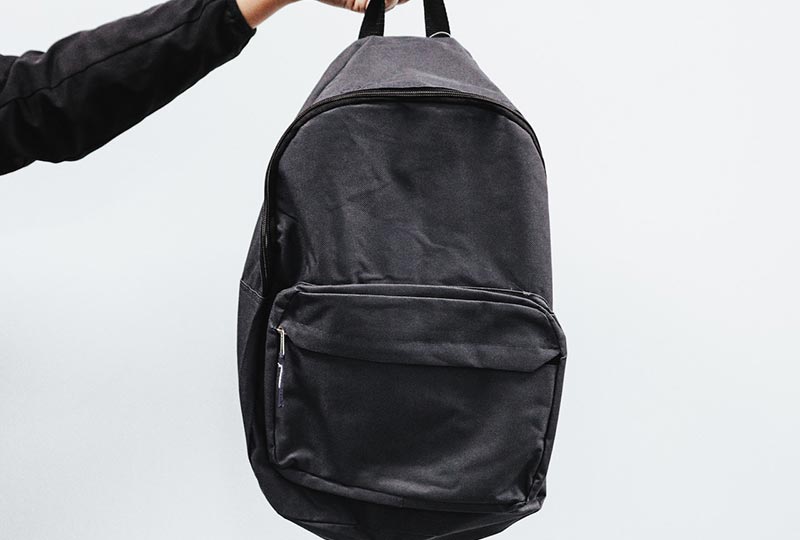 person holding a backpack
