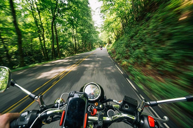 person riding motorcycle on the road