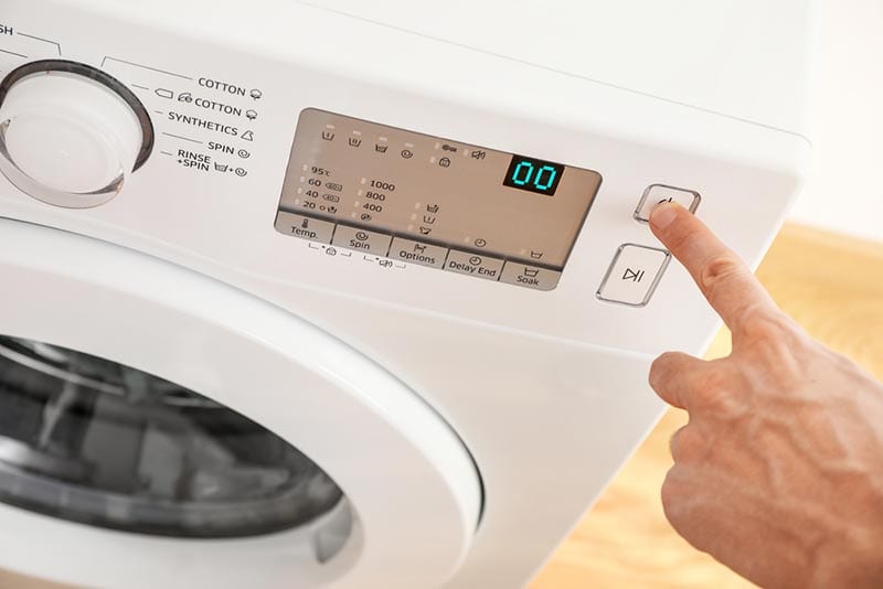 person switching on wachine machine