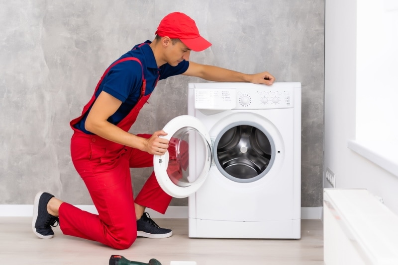 plumber repairing washing machine