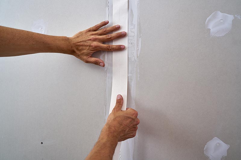 putting drywall paper tape