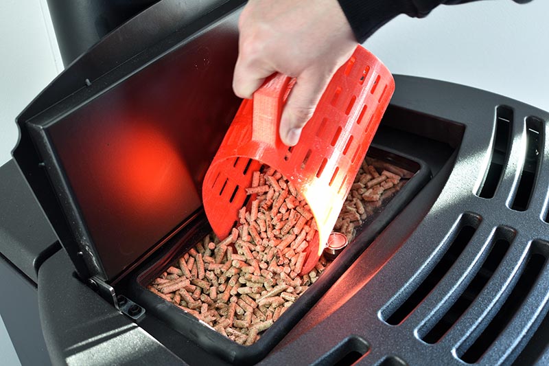putting pellets on the pellet stove