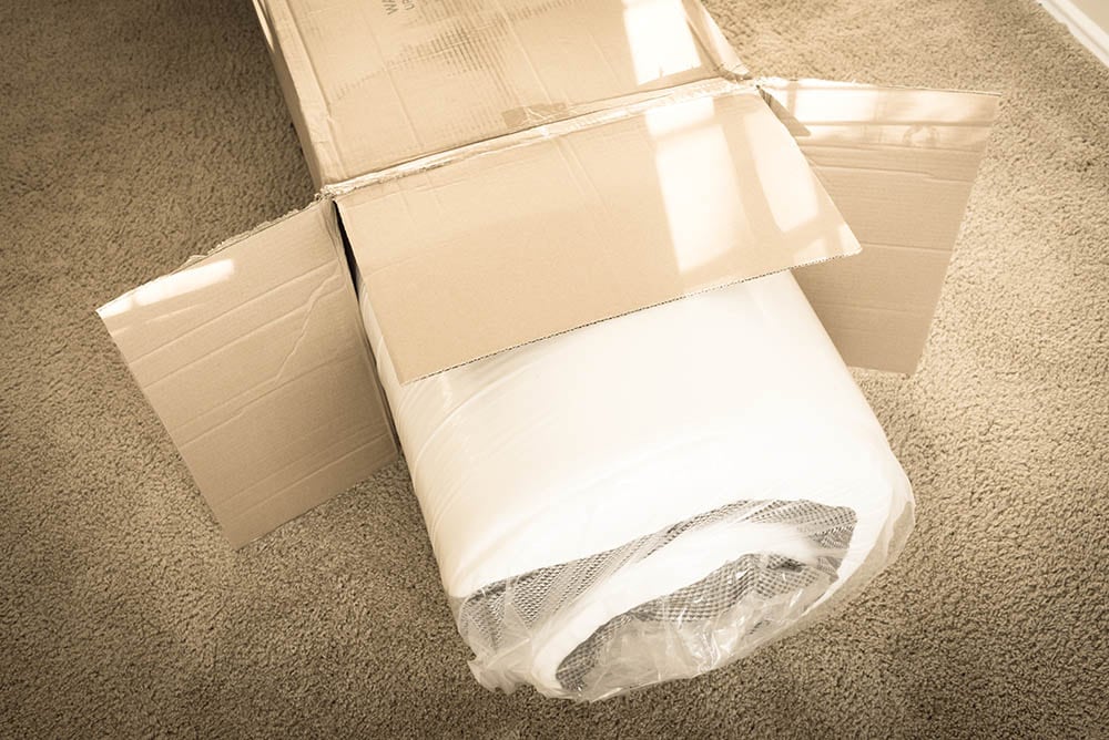 rolled mattress inside a box