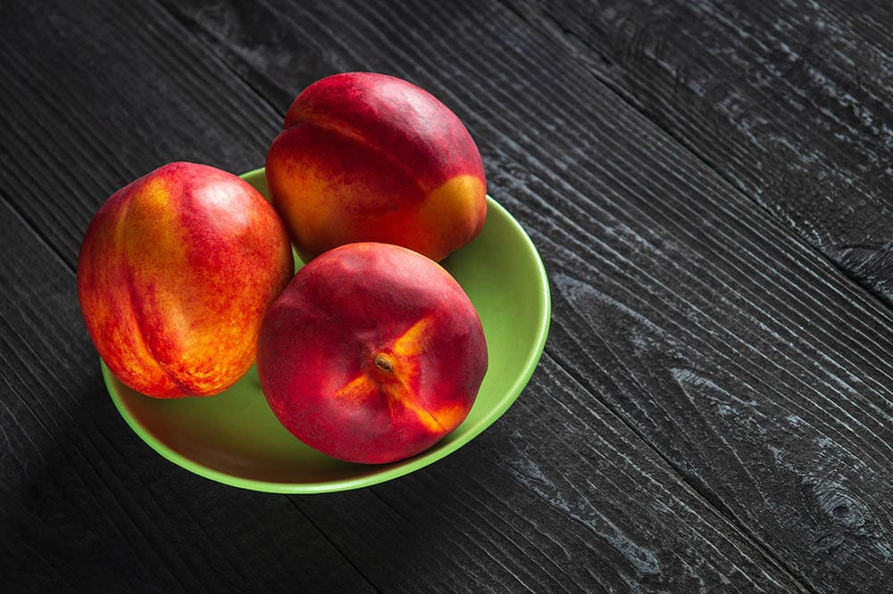 three ripe nectarines