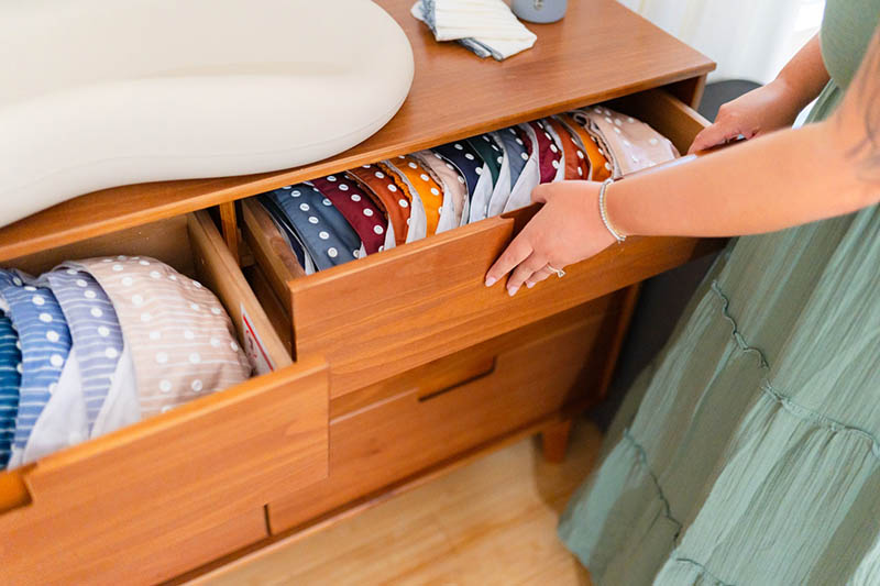 woman closing an organized drawer