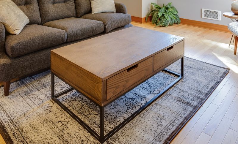 wood and metal table with couch in the living room