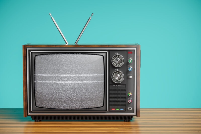 An old TV with a monochrome kinescope on wooden table