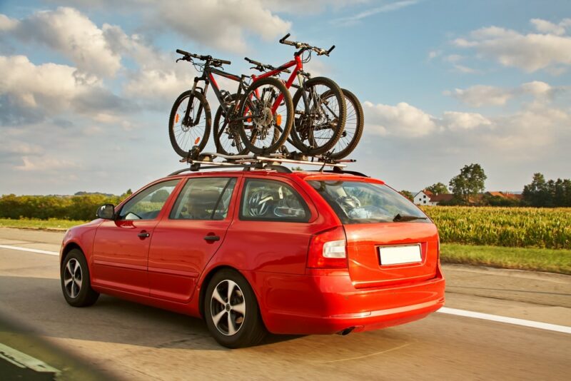 Bikes on a red car roof
