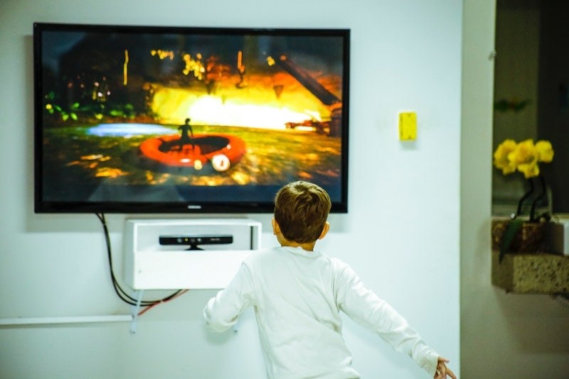 Boy infront of a television