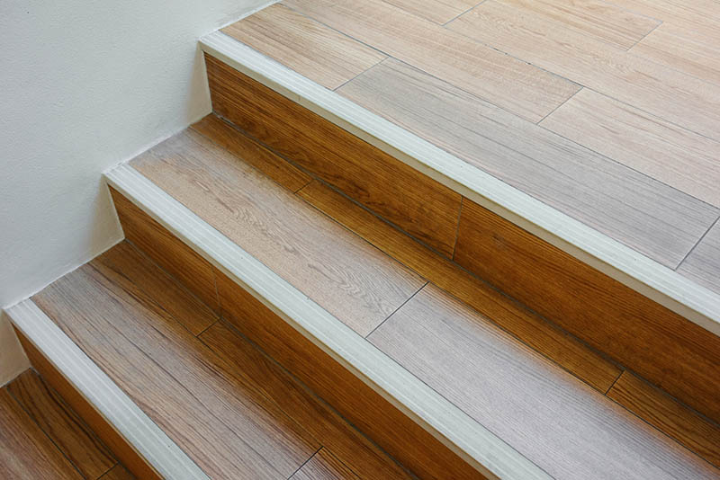 Modern wooden staircase with stair nosing strip