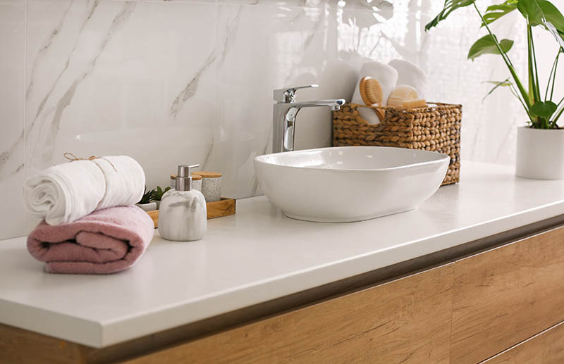 Stylish vessel sink on light countertop in modern bathroom