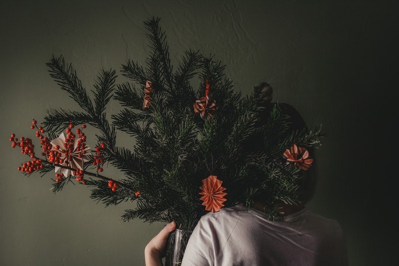 Woman holding a pruned holly plant for decoration