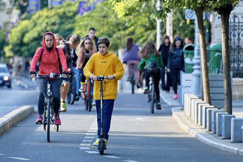Young Man Riding Electric Scooter