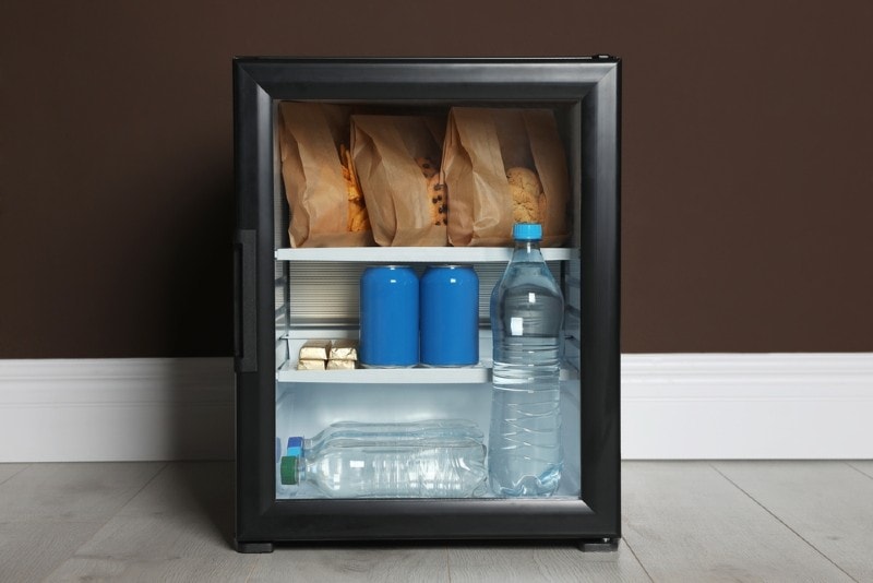 a mini fridge with food and water