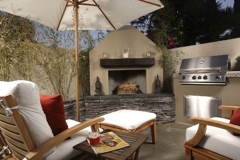 a patio with an outdoor fireplace