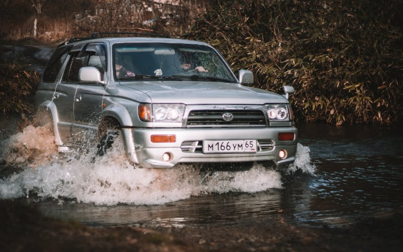 an SUV car crossing water