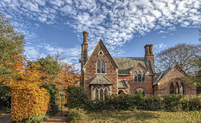 brick house with yard during fall