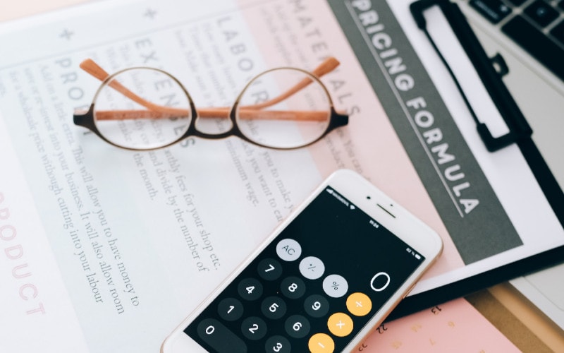 calculator app showing zero on smartphone on top of pricing document