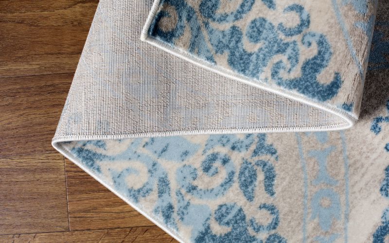 carpet rug folded on wood floor