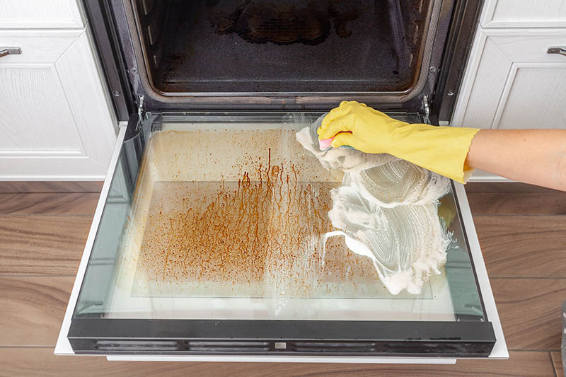 cleaning an over door in the kitchen