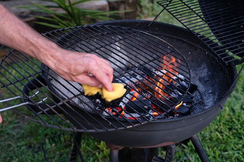 cleaning a grill with a cloth