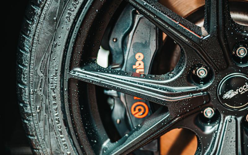 closeup of wet car wheel and brake