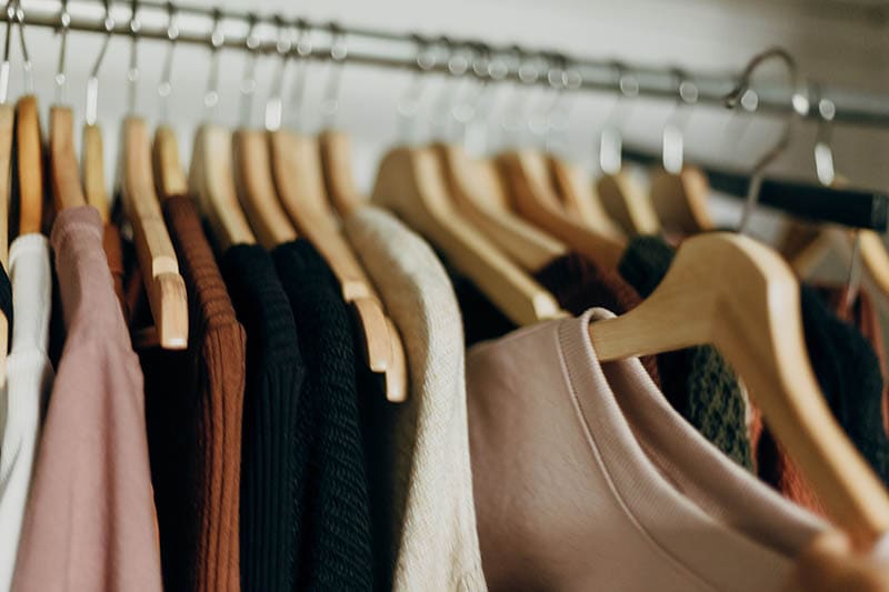 clothes hanged in wooden hangers