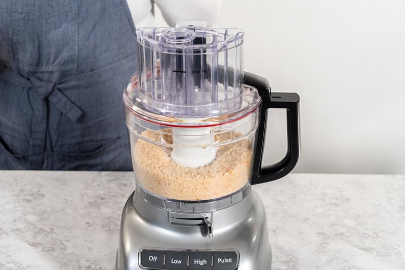 crumbling stale bread in a food processor