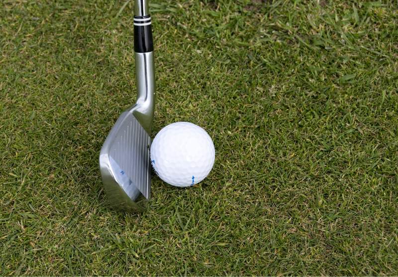 golf club and ball on the grass
