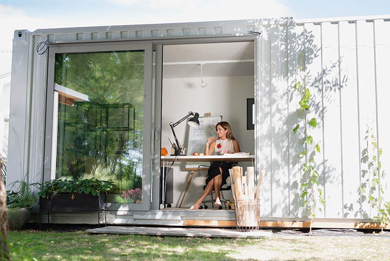 home office in container house in backyard