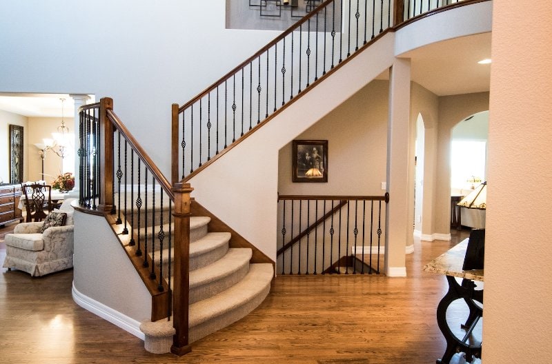 indoor staircase with wood and metal handrails