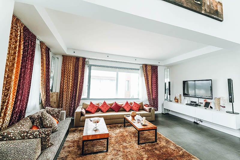 living room with assorted throw pillows and curtains