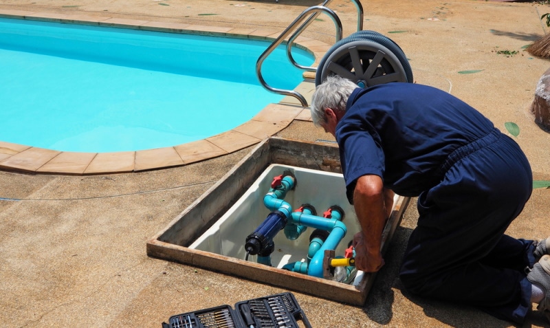man fixing pool pump