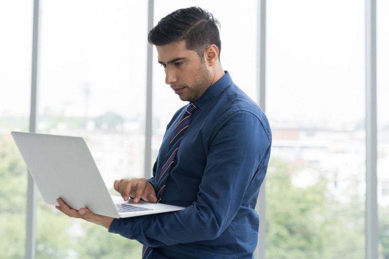 man holding laptop