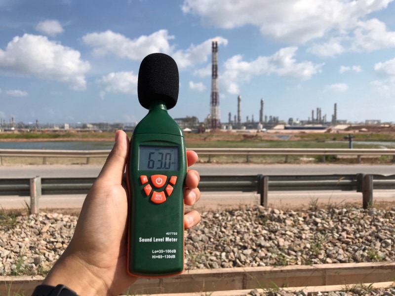 man holding sound level meter