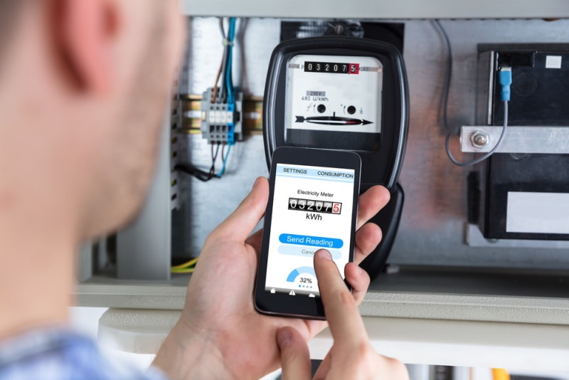 man reading electric meter