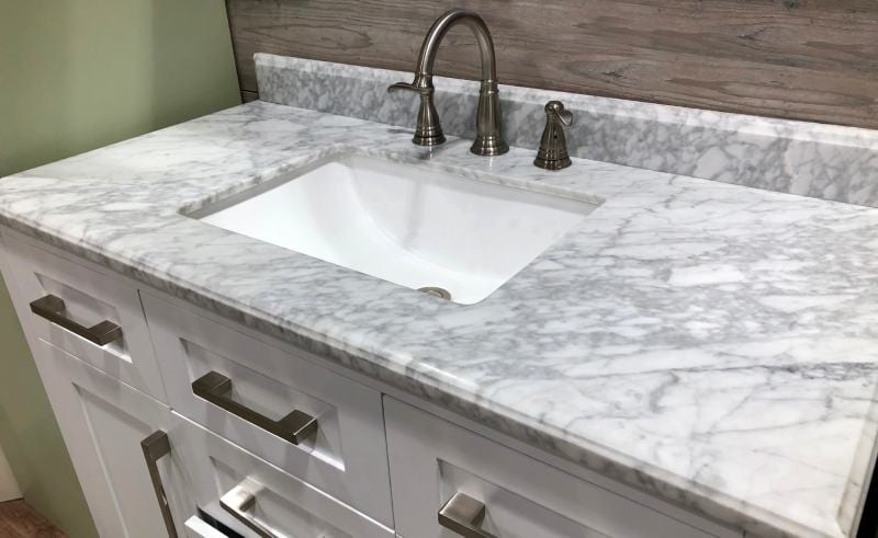 marble countertop with white wooden cabinets
