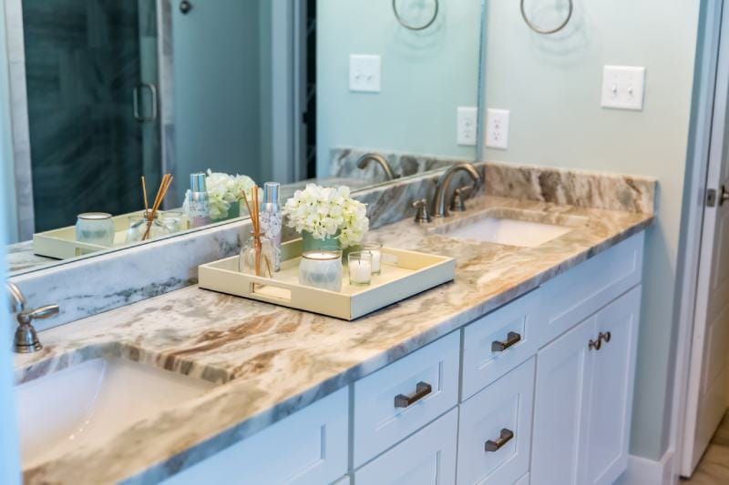 modern bathroom with granite countertops and a tile floor and double sinks