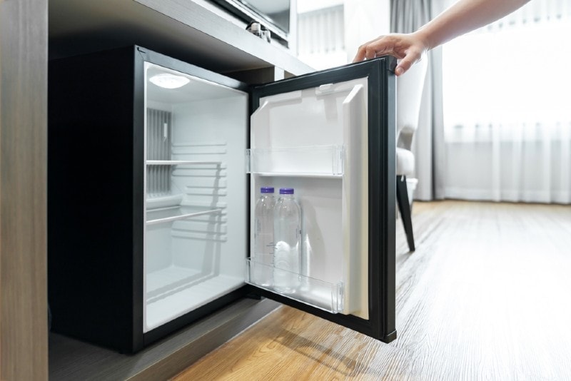 owner opening his mini fridge