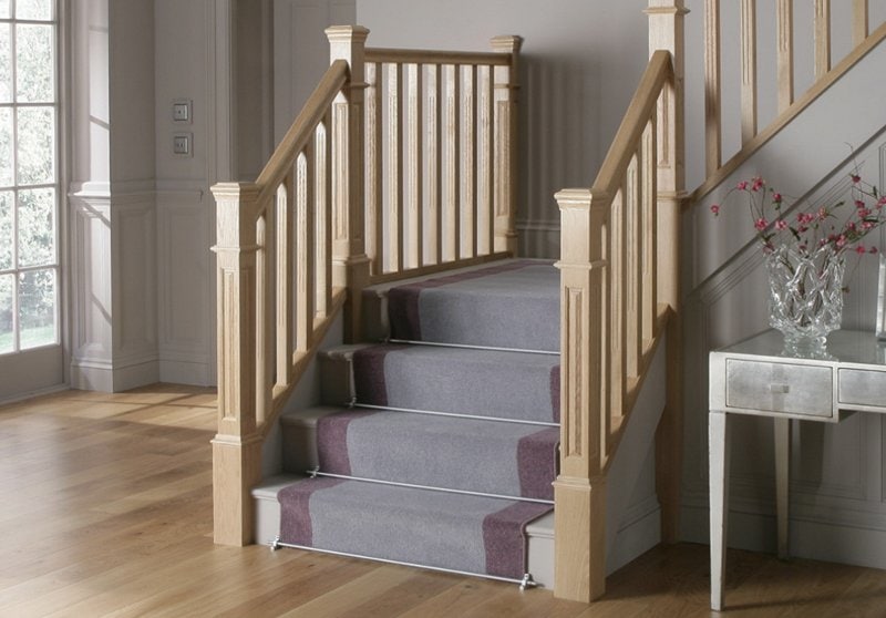 purple stair runner on wooden indoor stairs