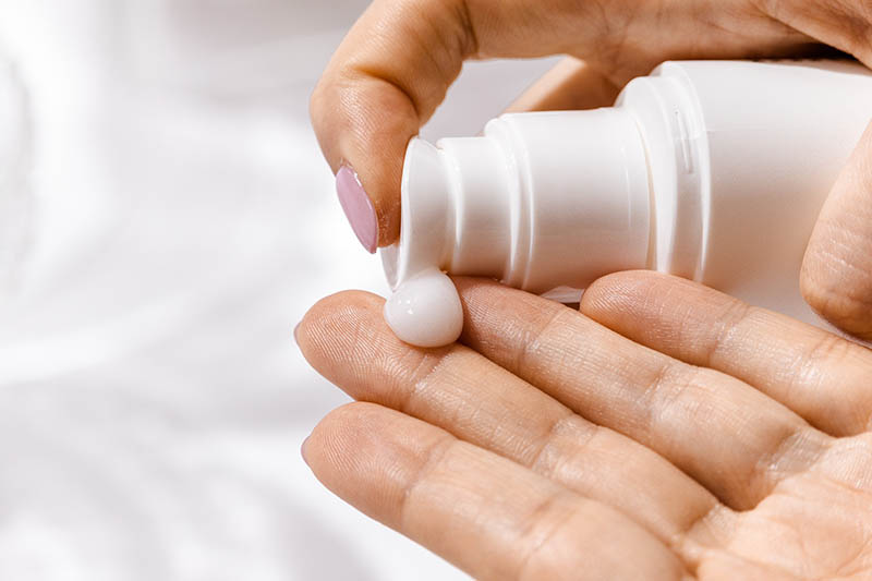 putting lotion on hands